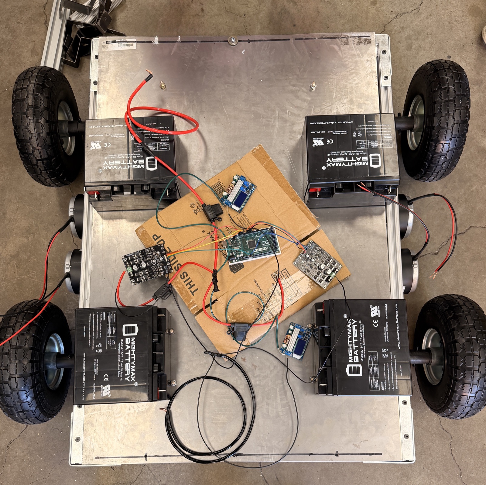 X-FLEX bench test: Arduino Mega, Cytron MDD10A motor drivers, MightyMax batteries wired to the four-wheel base